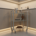 A compact, innovative kitchen serving trolley constructed with high-grade frosted glass shelves and a pastel grey powder-coated steel frame. Arranged in a corner near custom cabinetry with subtle recessed lighting, the trolley is displayed carrying neatly arranged contemporary kitchenware, reflecting thoughtful organization. Soft ambient under-cabinet lighting provides a warm, inviting glow, enhancing the frosted glass texture and providing gentle highlights. The atmosphere feels both creative and highly disciplined, with clear lines and precisely arranged elements. Captured at a low angle for a dynamic depth, the photographic realism and minimalist style reinforce the site’s focus on versatile, high-quality kitchen solutions.